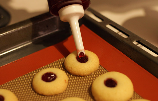 Das durch das backen eingefallene Gelee vorsichtig mit einem weiteren Klecks Gelee auffüllen.